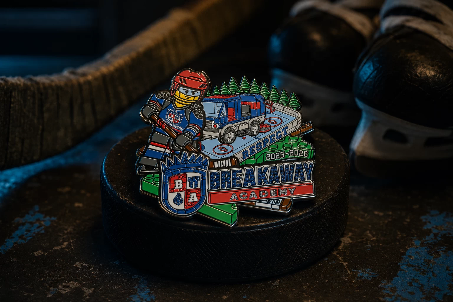 Art-directed lifestyle visualization of a Breakaway Academy hockey pin displayed on a puck beside skates.