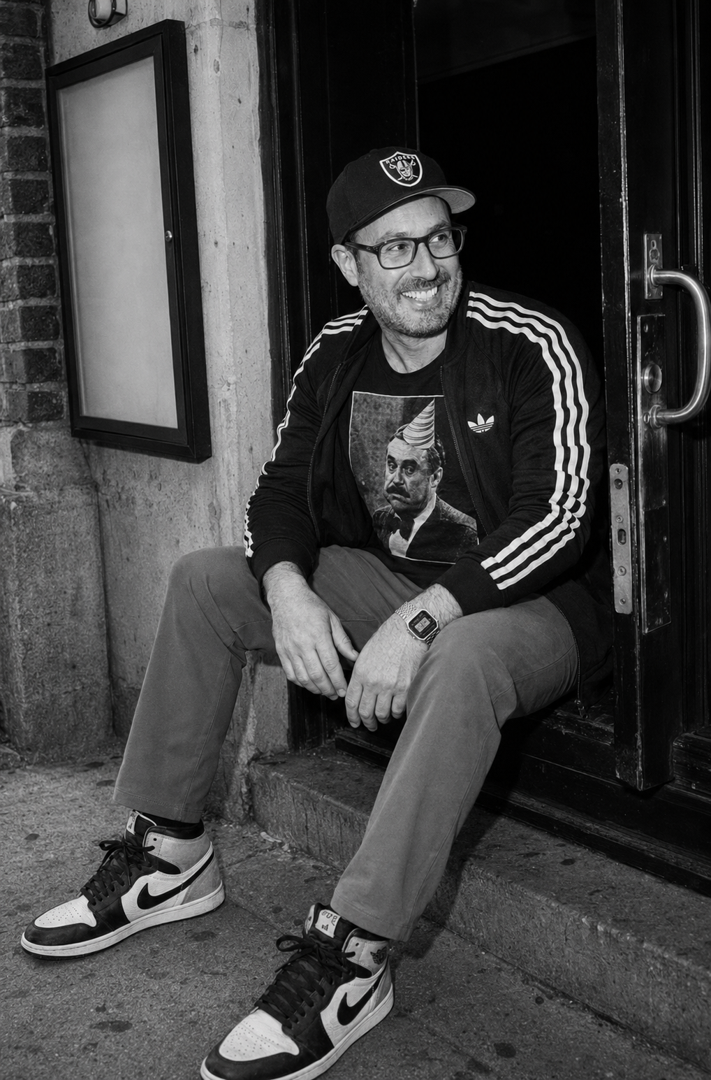 Ben Corber seated in a doorway during an off-hours candid moment